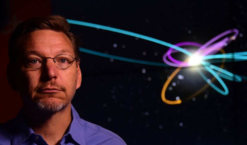 Caltech Astronomer Mike Brown poses in front of a screen showing the "Predicted Orbit", in yellow, of the 9th Planet at a Caltech Seismology Lab in Pasadena, California on January 20,2016. __Brown and his colleague, planetary scientists Konstantin Batygin, reported having "good evidence" of the 9th planet on the fringes of our solar system. / AFP / FREDERIC J BROWNFREDERIC J BROWN/AFP/Getty Images